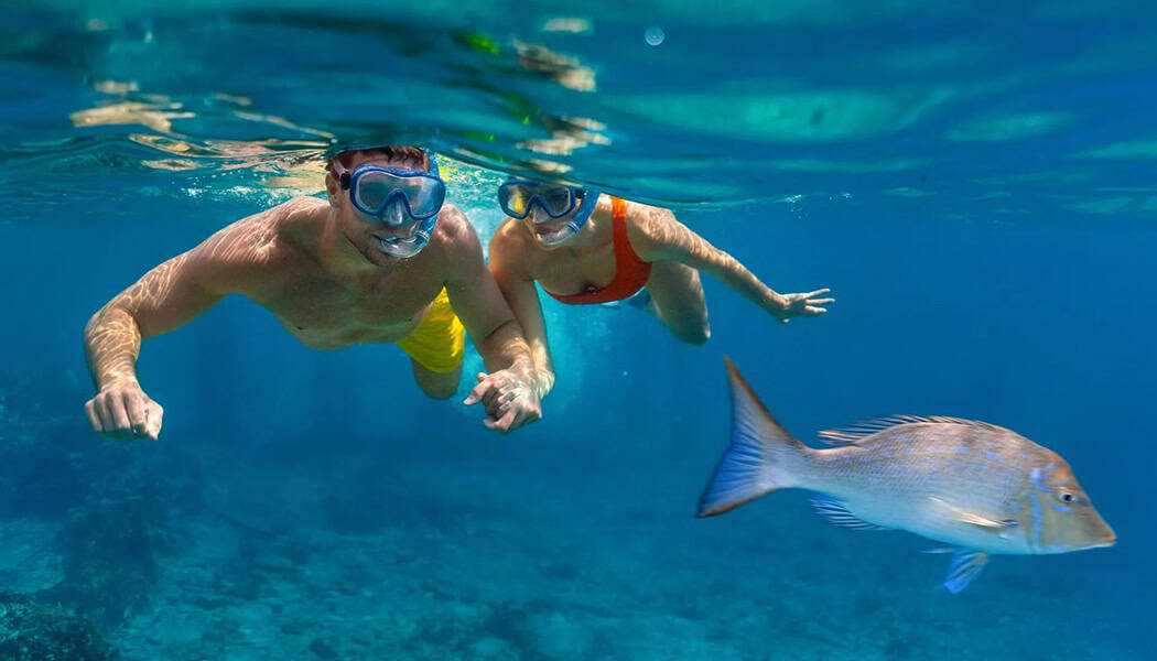 Couple snorkeling in clear water in St Croix